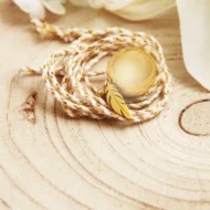 Bola de grossesse avec sa plume en acier inoxydable dorée